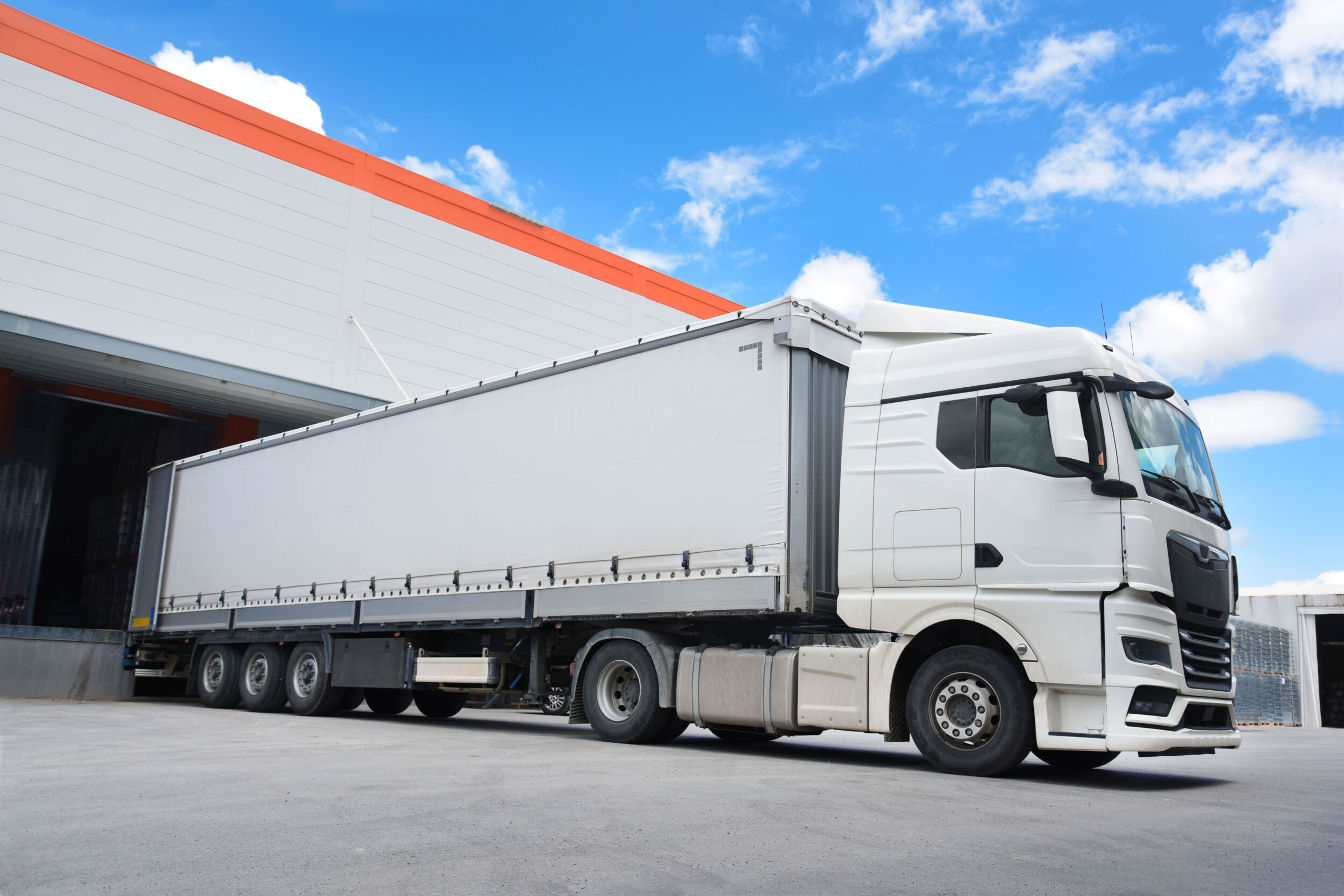 white truck in front of the warehouse a loading truck