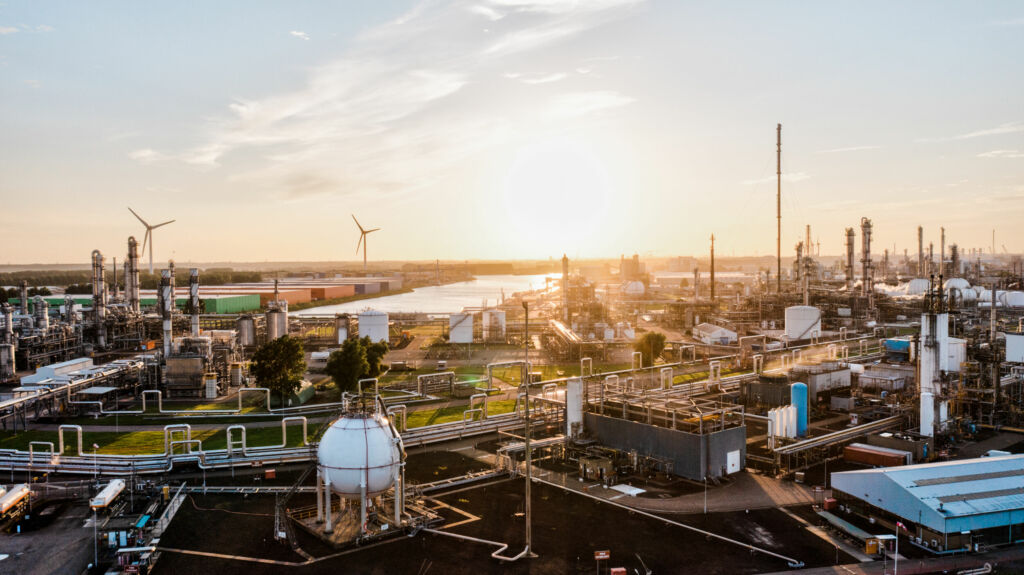 A surface level view of an industrial zone power station at sunset stock photo