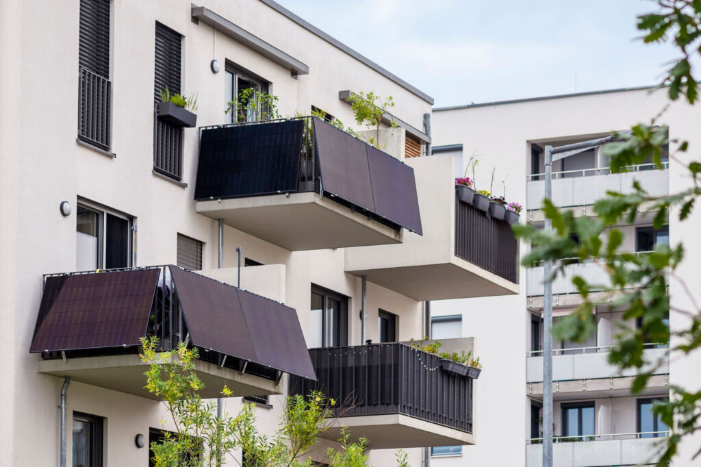 Balcony Solar Panels for Strata Apartment Buildings. Mini Solar Power Station on Balconies of Modern Apartment Bilding in Germany