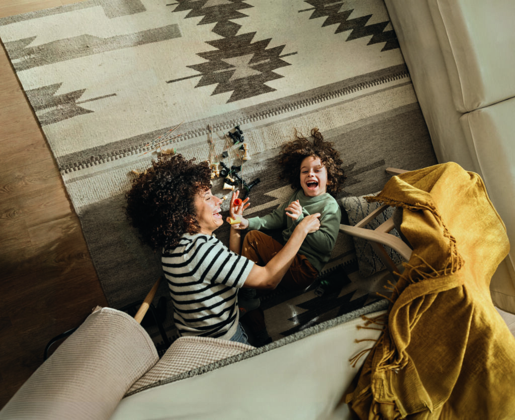 A joyful moment where a mother and son share laughter and playti