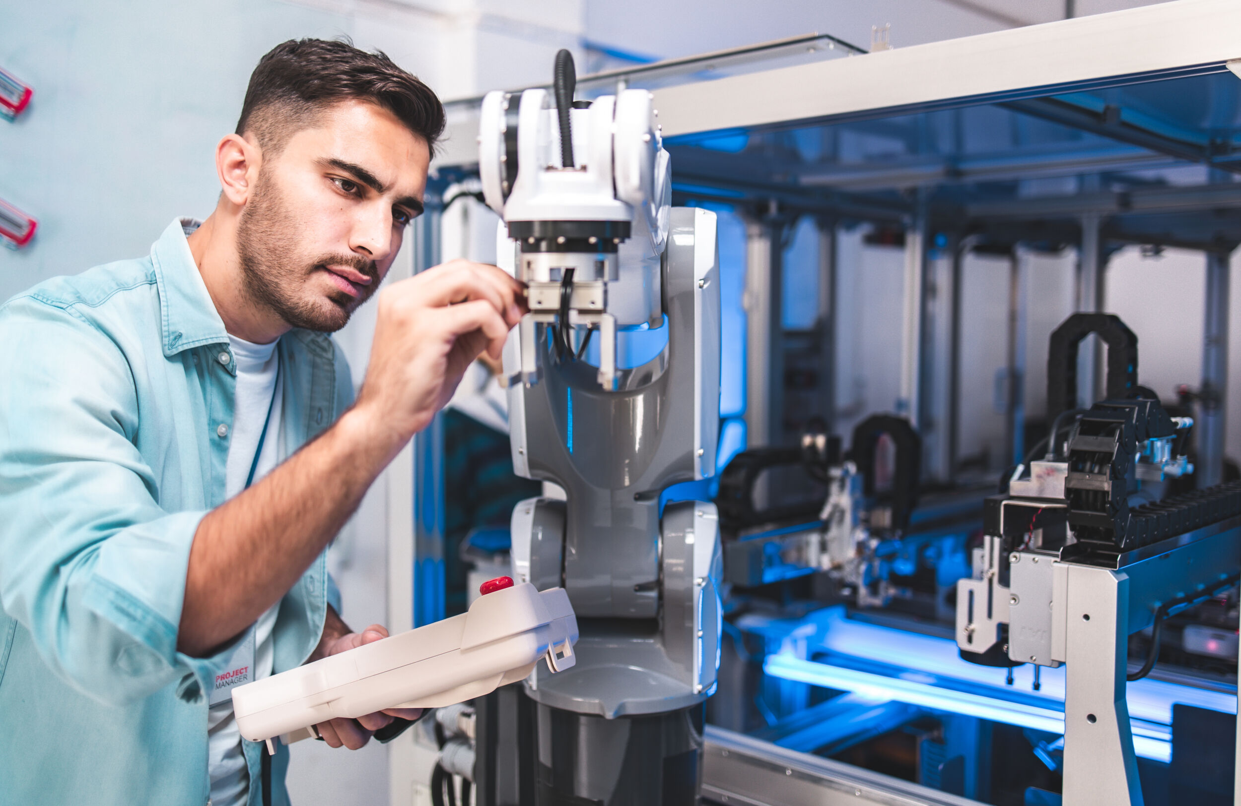 Male Engineers Maintenance Robot Arm at Lab. he are in a High Te