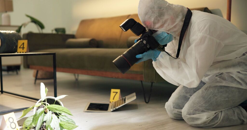 Csi, photographer and evidence at crime scene for investigation of house burglary or murder analysis. Forensic, person and digital pictures in hazmat for observation, examination and case research.