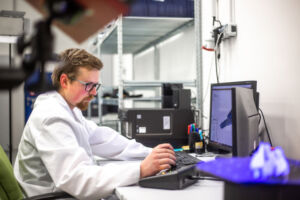 Quality engineer, metrologist scanning some moldings, components by professional optical 3D scanner with a turntable, automotive concept