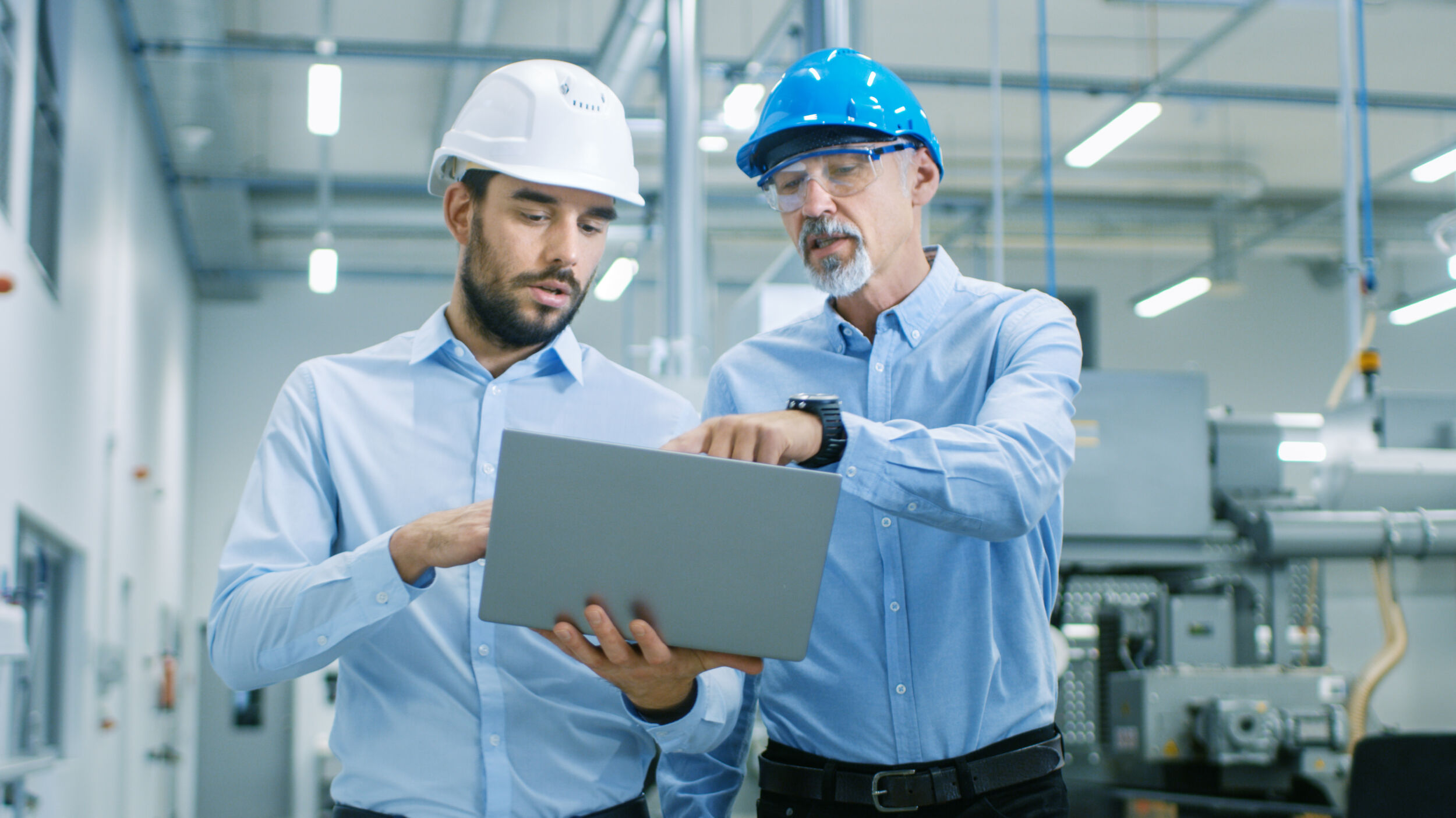 Head of the Project Holds Laptop and Discusses Product Details