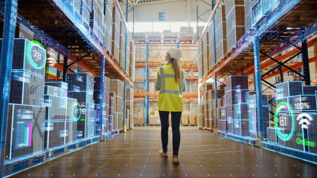 Futuristic Technology Retail Warehouse Worker Doing Inventory Walks when Digitalization Process Analyzes Goods Cardboard Boxes Products with Delivery Infographics in Logistics Distribution Center