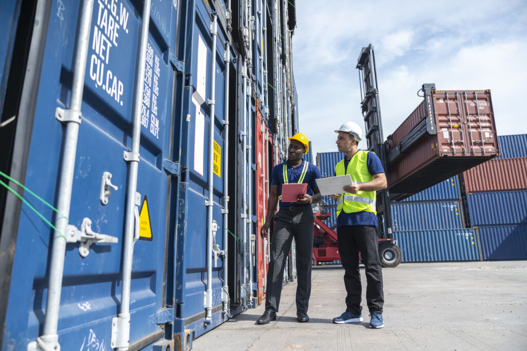 Multi ethnic men working at shipping port