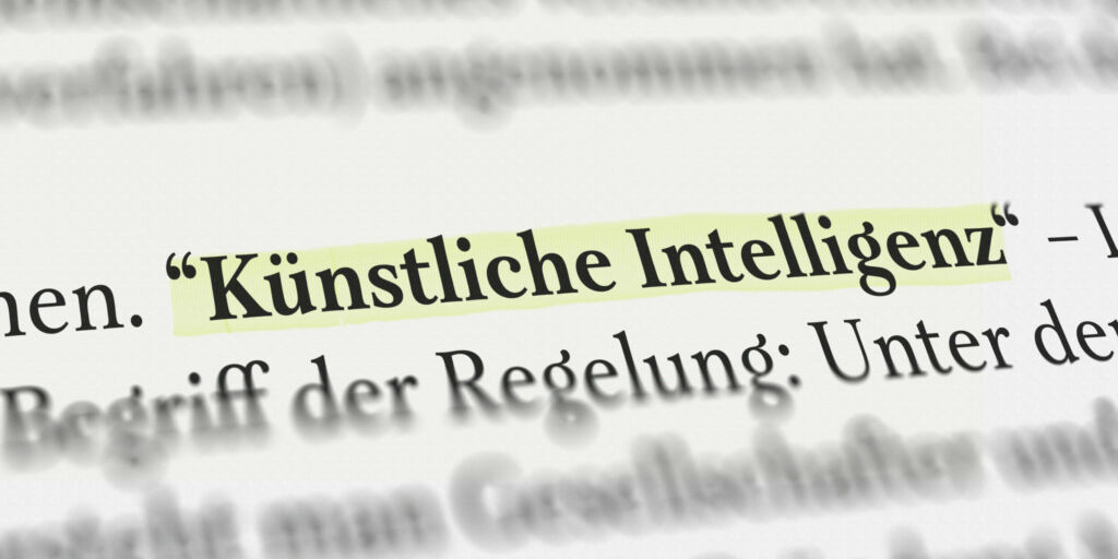 Fragmentierte Regulierung: Verpasst die EU den Anschluss im KI-Zeitalter? 1 Das Wort Kuenstliche Intelligenz im Buch mit Textmarker markiert