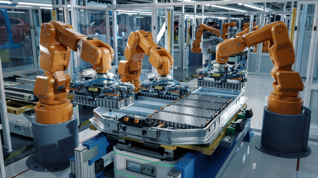 Die Top-Investitionsbereiche der Zukunft 1 Advanced Orange Industrial Robot Arms Assemble EV Battery Pack on Automated Production Line. Row of Robotic Arms inside Automotive Plant Assemble Batteries. Modern Electric Car Smart Factory.