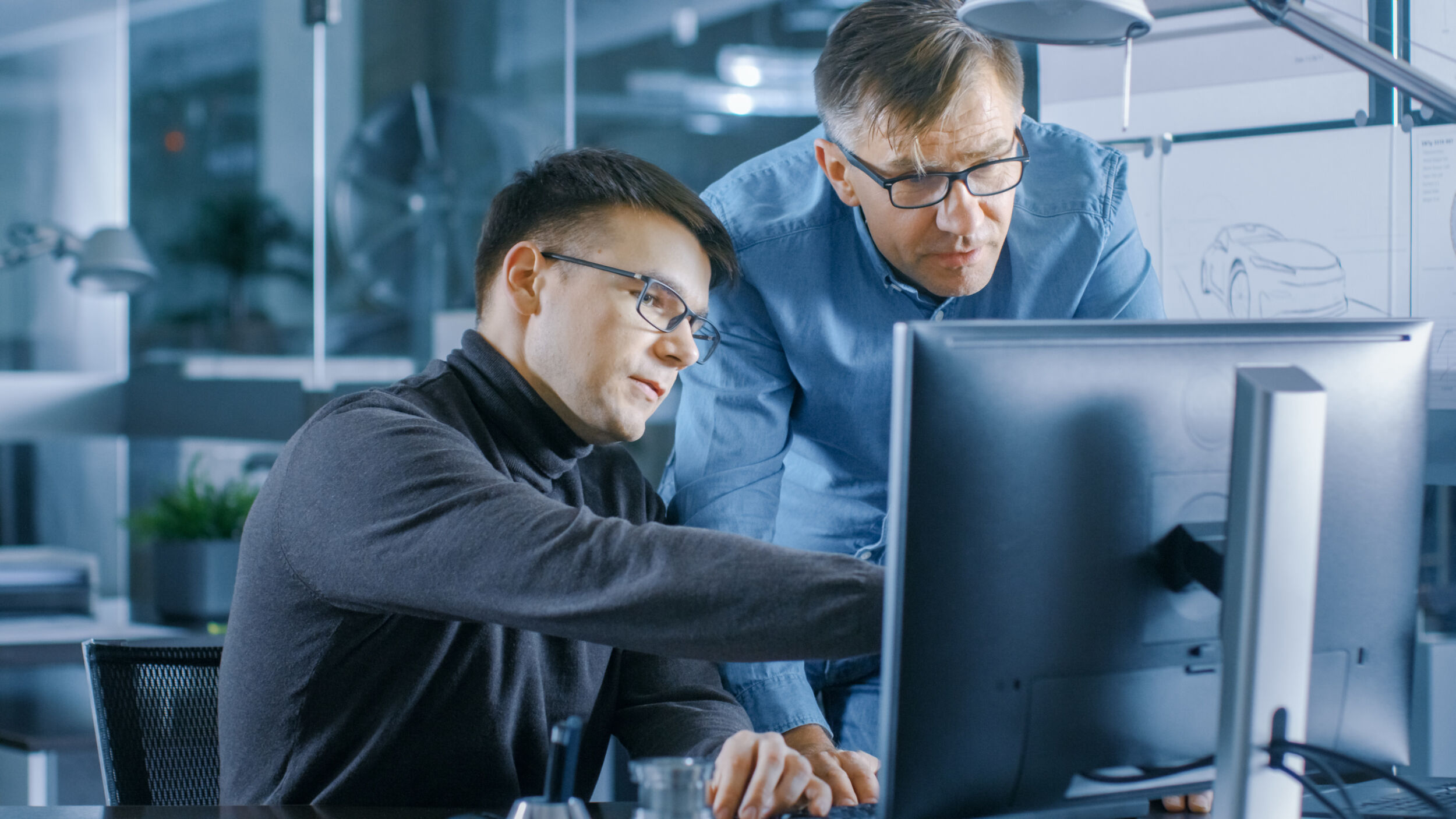 Experienced Senior Engineer Consults Young Designer about Projec