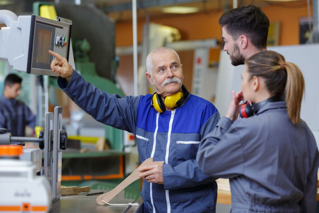 Übernahmen schrumpfen und viele Ausbildungsstellen bleiben unbesetzt 1 team of engineers having discussion in factory