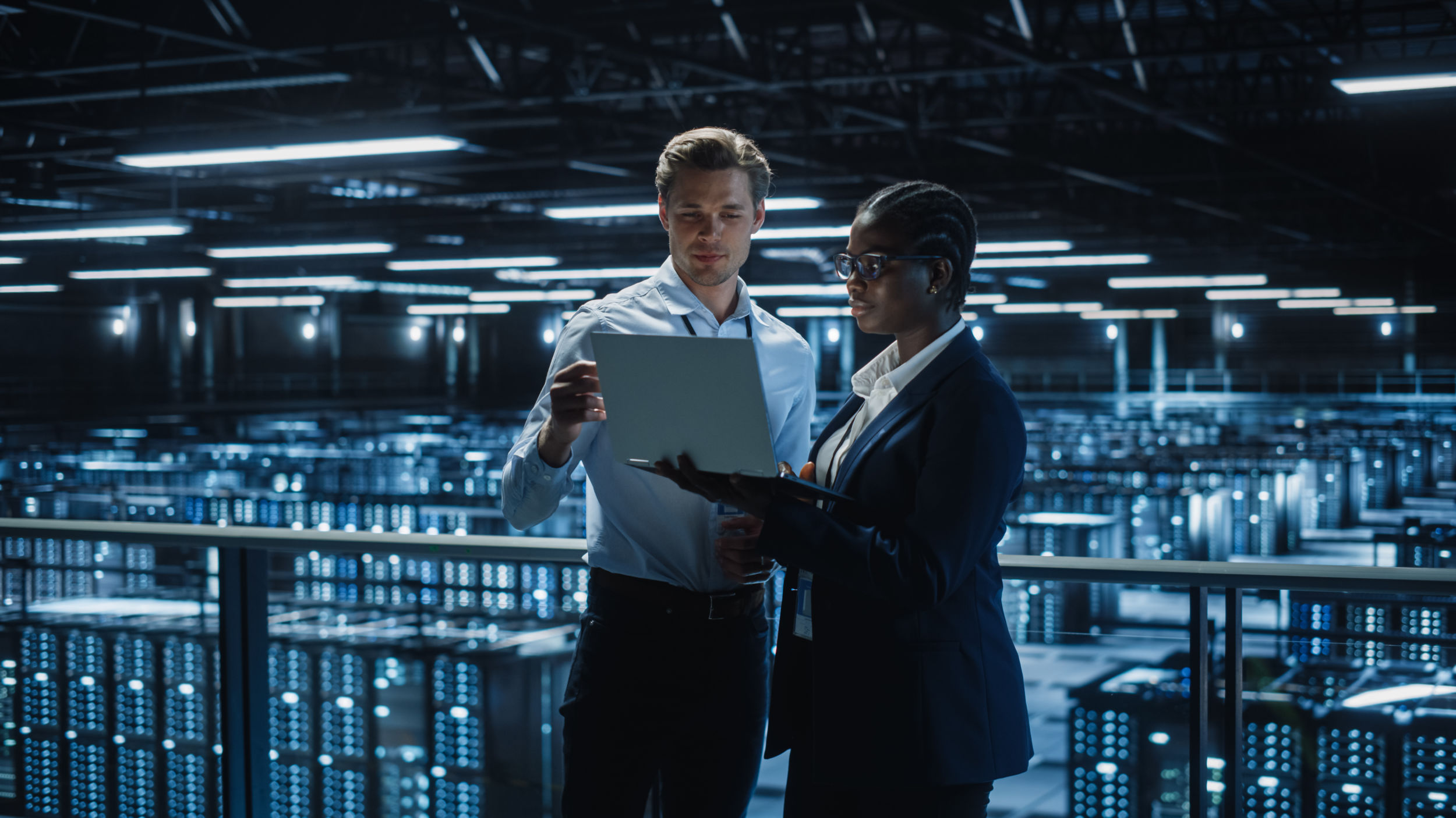 Data Center Female e Business Enrepreneur and Male IT Specialist