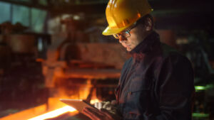 EngineerInGlassesUsingTabletPcInFoundry.IndustrialEnvironment