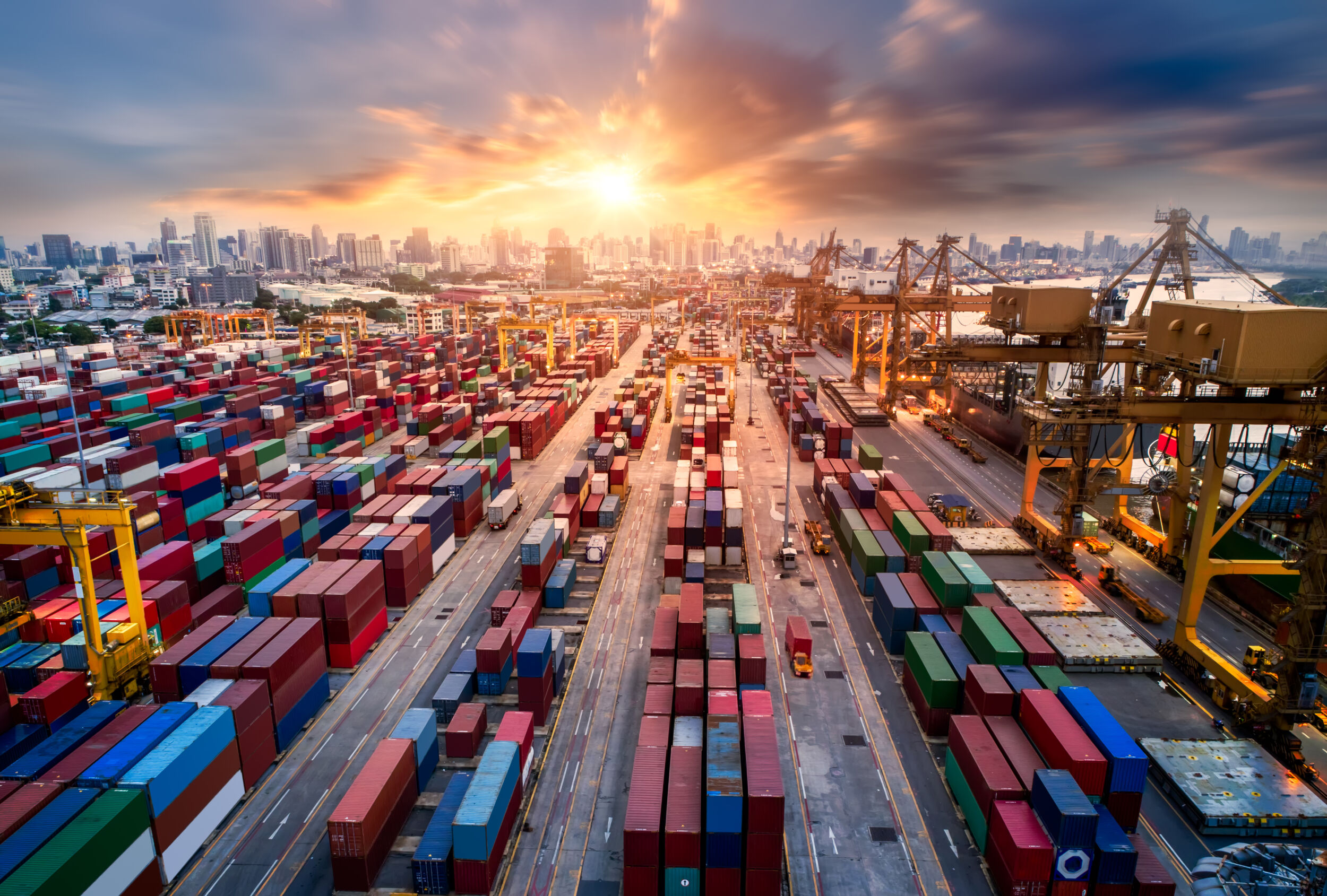 Logistics and transportation of Container Cargo ship and Cargo plane with working crane bridge in shipyard at sunrise logistic import export and transport industry background