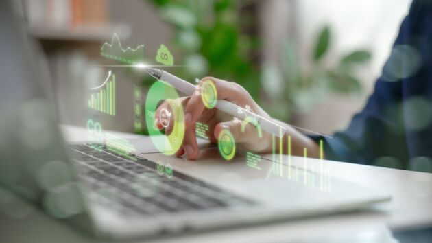 Hand analyzing environmental data with net zero dashboard carbon footprint metrics and green analytics. Concept of ESG sustainability eco technology and digital climate solutions